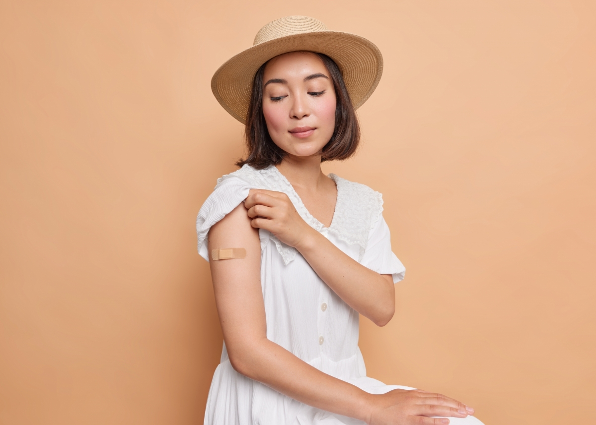 i-got-my-coronavirus-vaccine-serious-asian-lady-looks-attentively-place-inoculation-wears-aid-band